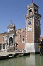 Italy, Veneto, Venice, Porta del Arsenale with clock tower & lion statues.