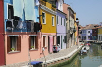 Italy, Veneto, Venice, Burano, colourful houses along canalside.