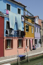 Italy, Veneto, Venice, Burano, colourful houses along canalside.