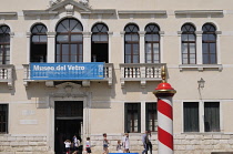 Italy, Veneto, Venice, Murano, family passing Glass Museum.