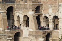 Italy, Lazio, Rome, Colosseum, view of Colosseum interior showing arches & different levels with people at viewpoints.
