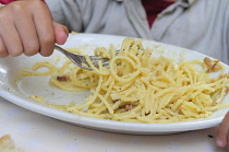 Italy, Lazio, Rome, child eating spaghetti carbonara.
