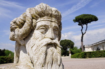 Italy, Lazio, Rome, Centro Storico, Villa Medici, stone head in Villa Medici gardens.