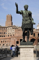 Italy, Lazio, Rome, Froi Imperiali, statue of Trajan with Trajan's market behind.