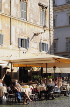 Italy, Lazio, Rome, Trastevere, Piazza di Santa Maria de Trastevere, cafes on the Piazza.