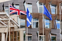 Scotland, Edinburgh, Scottish Parliament Building with Union Jack Scottish and EU flags outside.