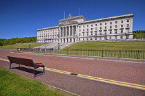 Northern Ireland, Belfast, Stormont, Parliament or Northern Ireland Assembly Buildings with double yellow lines and seat on roadway in the foreground.