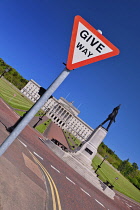 Northern Ireland, Belfast, Stormont, Angular view of Northern Ireland Assembly building with statue of Lord Edward Carson and Give Way sign in the foreground.