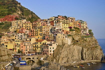 Italy, Liguria, Cinque Terre, Manarola, General vista of the town bathed in evening sunshine as seen from Punta Bonfiglio opposite.