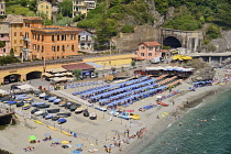 Italy, Liguria, Cinque Terre, Monterosso al Mare,  Vista of the Old Town with sandy beach in the foreground.