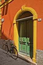 Italy, Liguria, Cinque Terre, Monterosso al Mare, Colourful doorway  and facade with bicycle outside on the street.