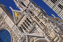 Italy, Tuscany, Siena, Angular view of a section of the facade of Siena Cathedral from Piazza del Duomo.