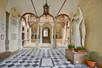 Italy, Tuscany, Siena, Casa Santuario di Santa Caterina, Courtyard with large statue of St Catherine.