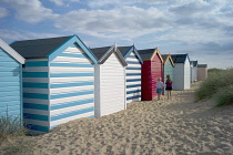 England, Suffolk, Southwold, Group of brightly coloured beach huts near Gun Hill.