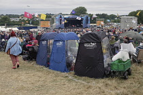 England, Oxfordshire, Three fold out chairs with weather proof plastic covers at Cropredy festival.