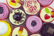 Studio shot of various colouful and decorated cup cakes.