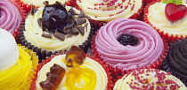 Studio shot of various colouful and decorated cup cakes.