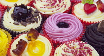Studio shot of various colouful and decorated cup cakes.
