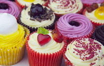 Studio shot of various colouful and decorated cup cakes.