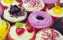 Studio shot of various colouful and decorated cup cakes.