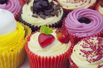 Studio shot of various colouful and decorated cup cakes.