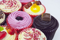 Studio shot of various colouful and decorated cup cakes.