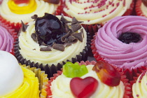 Studio shot of various colouful and decorated cup cakes.