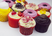 Studio shot of various colouful and decorated cup cakes.