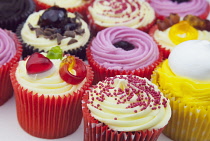 Studio shot of various colouful and decorated cup cakes.