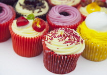 Studio shot of various colouful and decorated cup cakes.