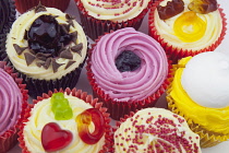 Studio shot of various colouful and decorated cup cakes.