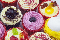 Studio shot of various colouful and decorated cup cakes.