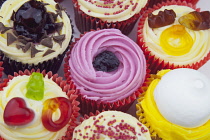 Studio shot of various colouful and decorated cup cakes.