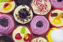 Studio shot of various colouful and decorated cup cakes.