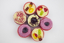Studio shot of various colouful and decorated cup cakes.