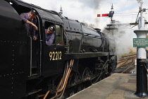 Transport, Railway, Steam, Locomotive with driver and stoker looking back along the platform.