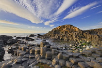 Ireland, County Antrim, Giants Causeway, Dramatic cloud pattern over the rocks at sunset.