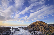 Ireland, County Antrim, Giants Causeway, Dramatic cloud pattern over the rocks at sunset.