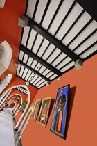 Ireland, County Kildare, Maynooth, St Patricks College, Angular view of brightly coloured hallway in the seminary with paintings of former  Irish cardinals on the walls.