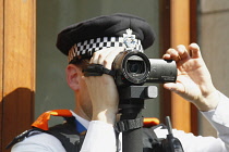 England, London, Police Video Surveillance Officer filming anti Trump demonstration.