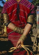 Thailand, North, People, Bracelets worn on the wrists and forearms of a woman from the Karen tribe.