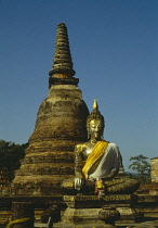 Thailand, North, Sukhothai, Seated Buddha and chedi.