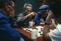 China, Yunnan Province, Kunming, Group of men playing chequers.
