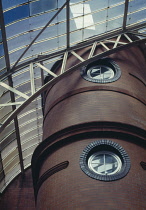 Scotland, Glasgow, Peoples Palace conservatory hothouse. Part view of glass roof and brick tower with circular windows.