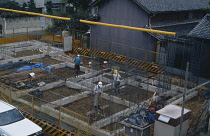 Japan, Honshu, General, Men working on construction of building foundations.