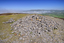 Ireland, County Sligo, Ben Bulben mountain seen from the summit of Maeve's Cairn on Knocknarea mountain with sea fog rolling in.