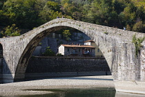 Italy, Tuscany, Lucca, Garfagnana, Bagni di Lucca, Devil's aka Maddalena's Bridge with people walking over the high arch
