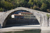 Italy, Tuscany, Lucca, Garfagnana, Bagni di Lucca, Devil's aka Maddalena's Bridge with people walking over the high arch