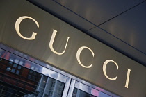 Germany, Berlin, Mitte, Friedrichstrasse, Illuminated Gucci fashion shop sign. **Editorial Use Only**