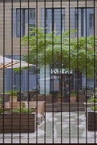 Germany, Berlin, Mitte, Private courtyard with security gates and outdoor seating.